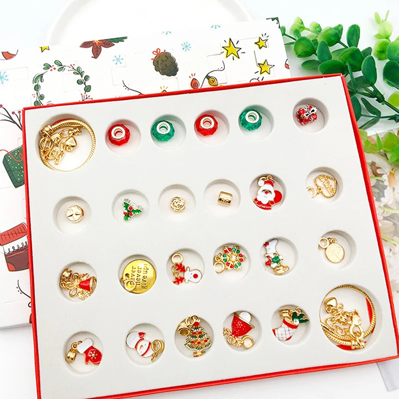 Open 24-compartment tray of gold-tone Christmas charms, beads and bracelets