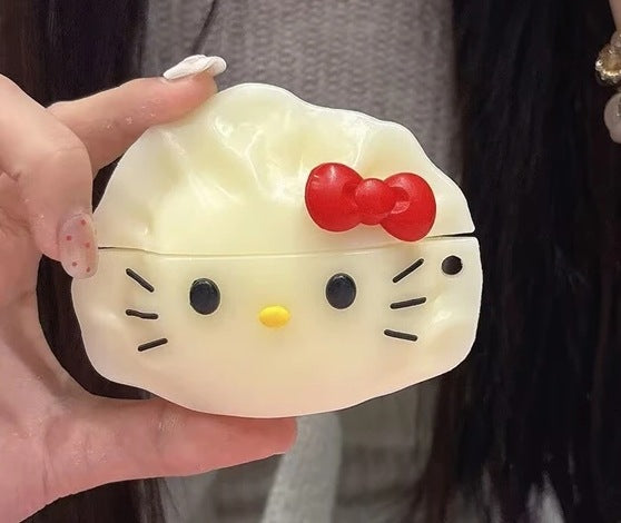 Close-up of the dumpling cat earbud case showing the whiskers, yellow nose and red bow