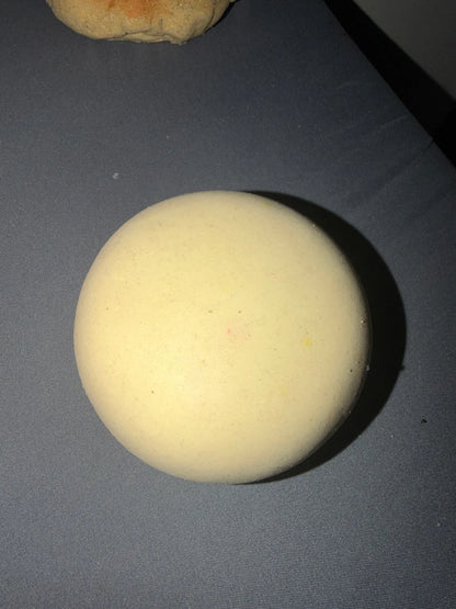 Cream Milk bun squishy from above on a gray surface