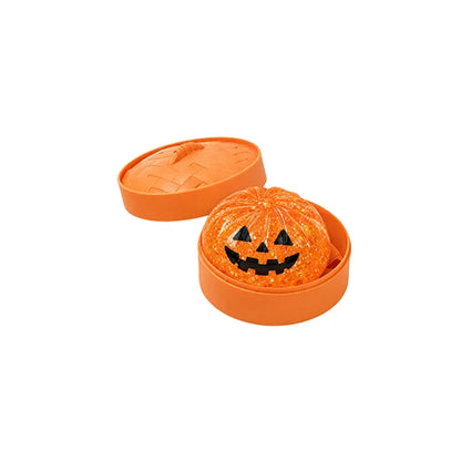 Orange jack-o'-lantern ghost bun squishy in an orange steamer with the lid off