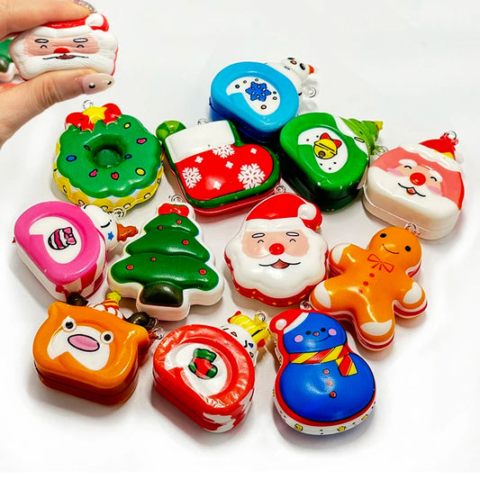 Assortment of Christmas squishies like Santa, gingerbread, a donut, a tree and a reindeer