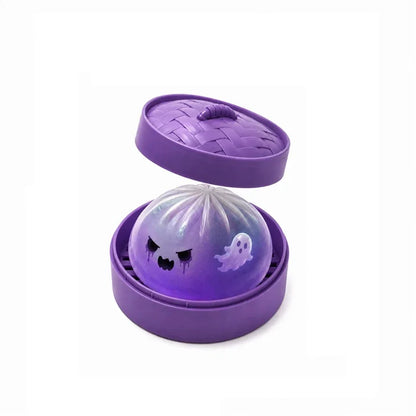 Purple ghost bun squishy sitting in a purple steamer with the lid lifted