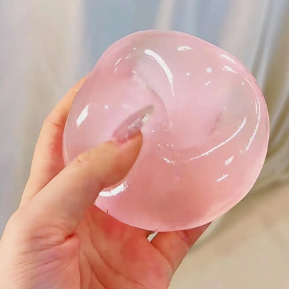 Hand squeezing a clear pink squishy ball