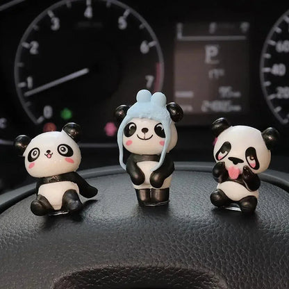 Three panda figures up close, including one wearing a blue hat