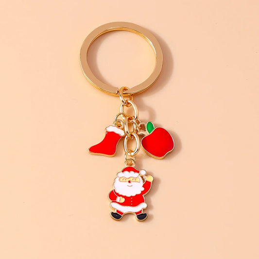 Gold-tone Christmas enamel keychain with Santa, a red stocking and a red mitten charm