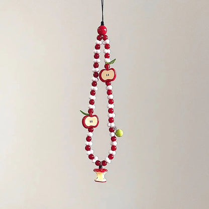 Red and white beaded phone charm strap with apple charms