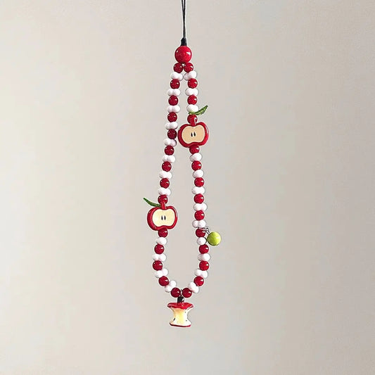 Red and white beaded phone charm strap with apple charms