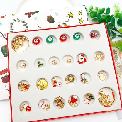 Open 24-compartment tray of gold-tone Christmas charms, beads and bracelets