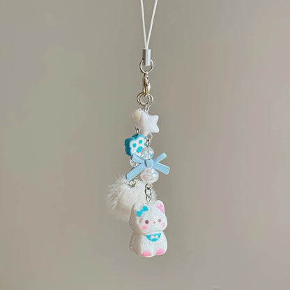 Blue cat bead phone strap with a blue bow, paw bead, star bead, pom-pom and white cat charm