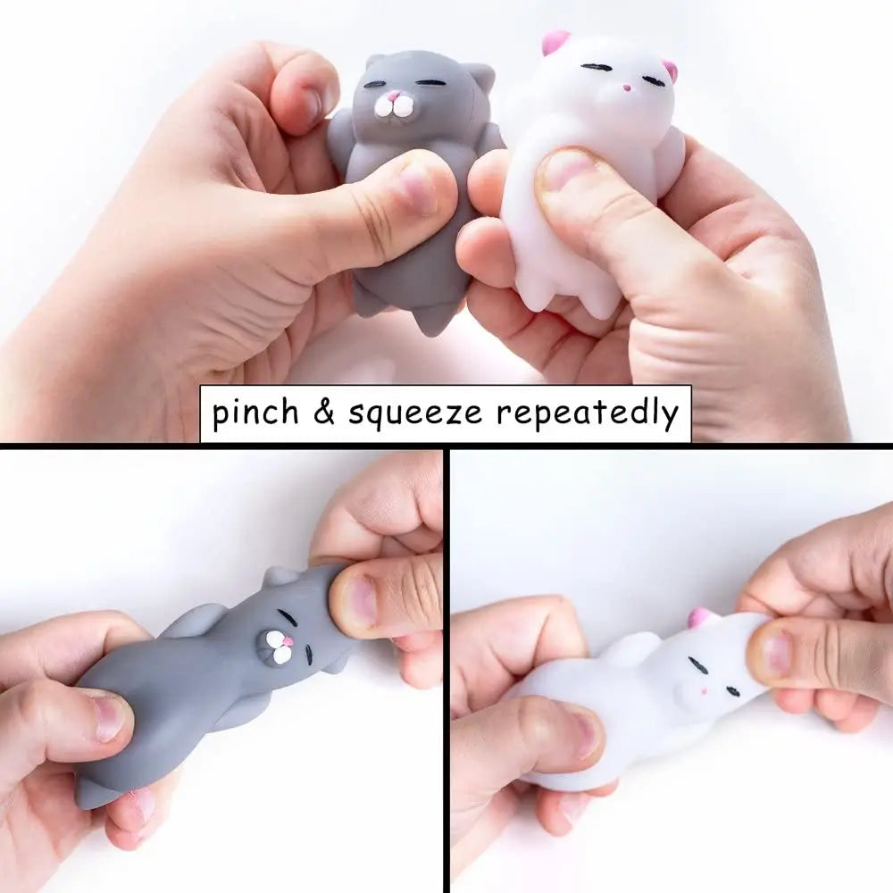 Hands squeezing gray and white mini mochi cat squishies