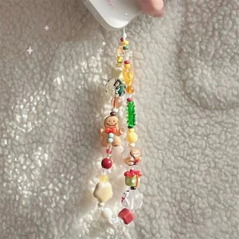 Holiday beaded phone strap with red, green and clear beads hanging from a phone