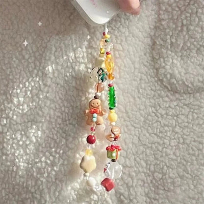 Holiday beaded phone strap with red, green and clear beads hanging from a phone