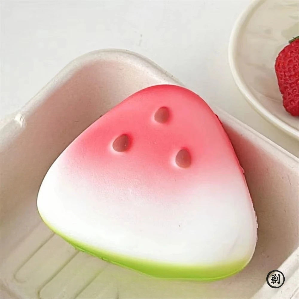 Watermelon slice squishy sitting in a small white tray