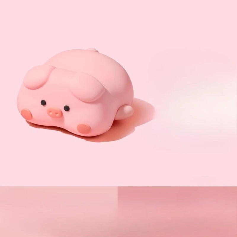 Pink 3D pig earbud case lying on its side
