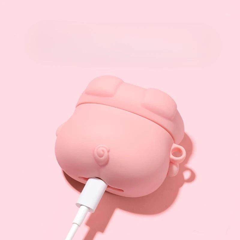 Back of the pink pig earbud case with curly tail and charging cable plugged in