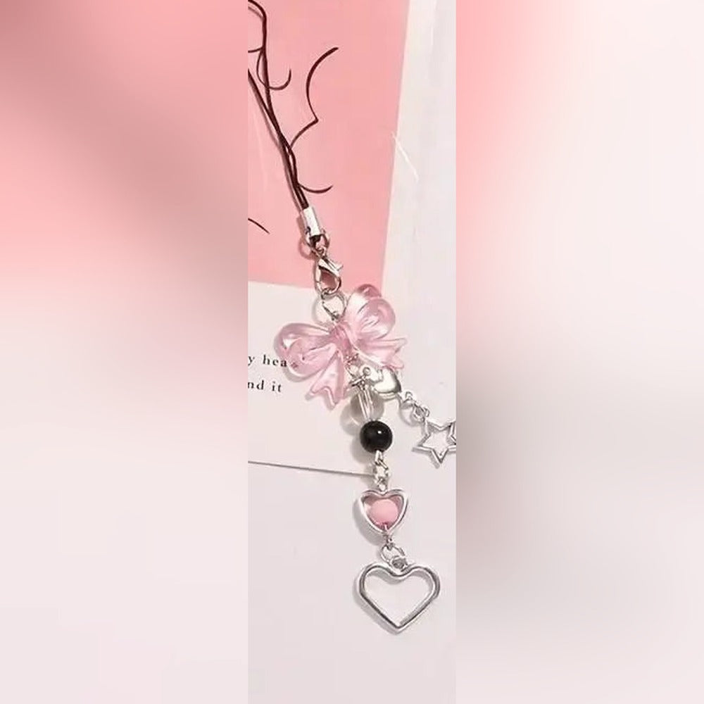 Pink bow beaded phone charm strap with phone loop, laid flat